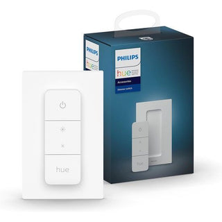 De Philips Hue-dimschakelaar wordt getoond voor de blauwe verpakking met productafbeeldingen en merkopdrukken. De witte schakelaar heeft vier knoppen en het Hue-logo, ontworpen voor het bedienen van je slimme verlichting.